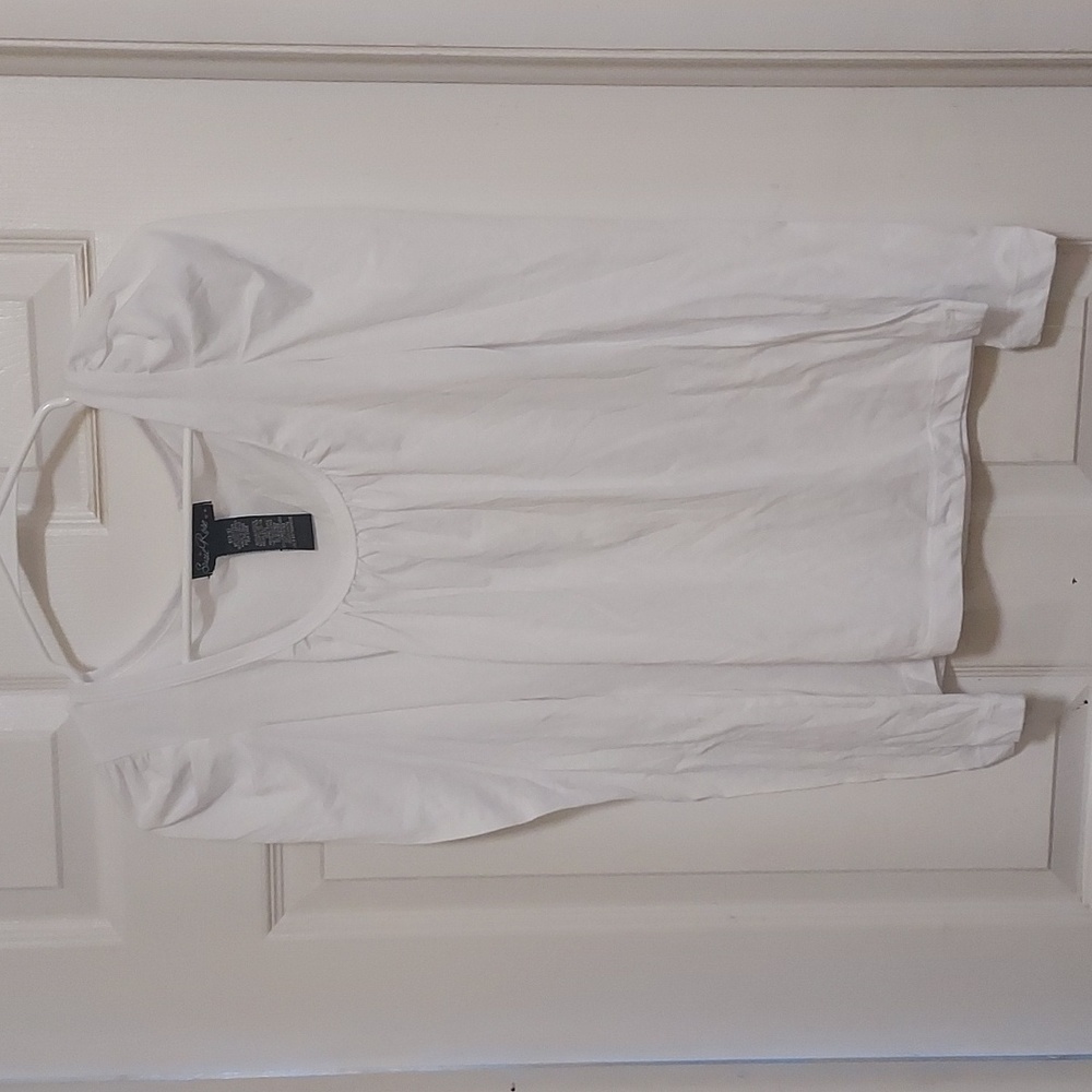White long sleeved ruffled shoulder detail top